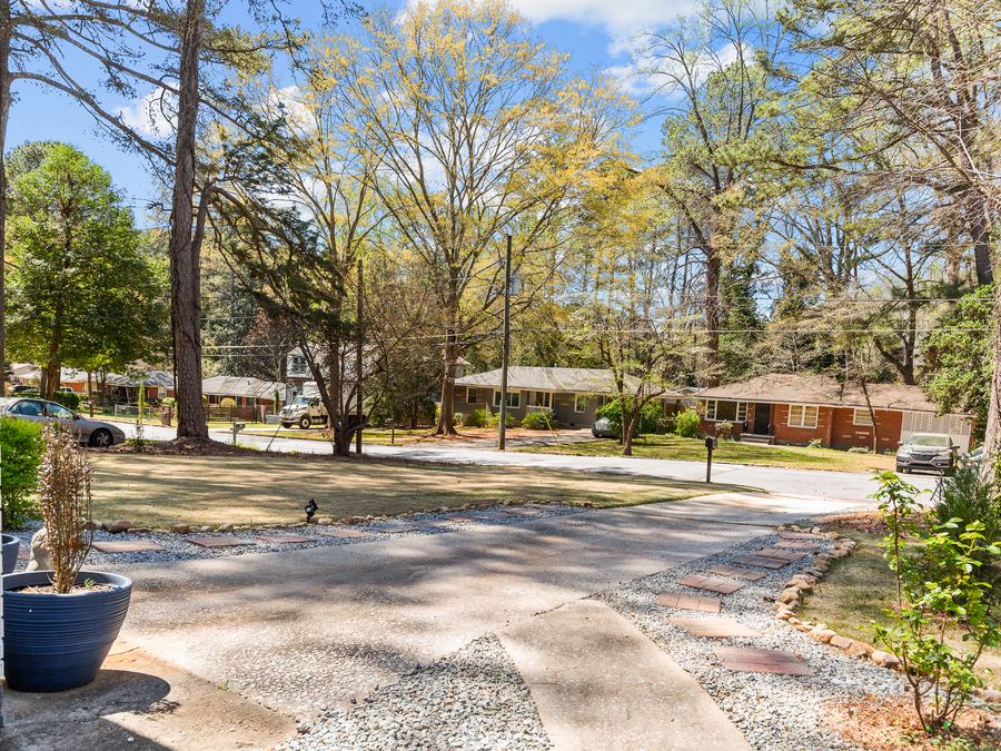 A quiet residential street lined with mature trees